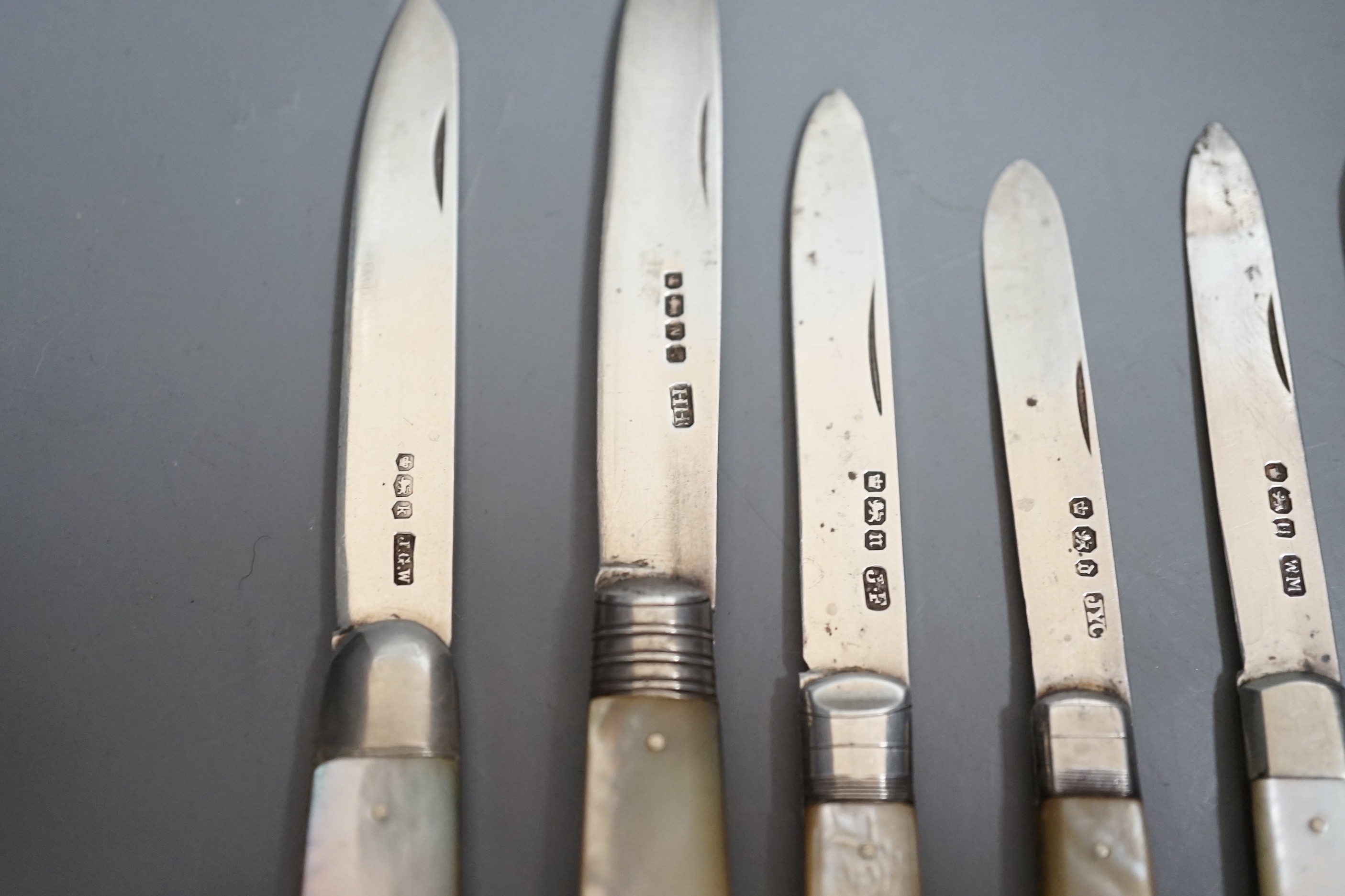 A collection of seven assorted mainly 20th century mother of pearl handled silver fruit knives and a silver cased pen knife.